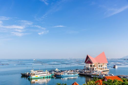 CHON BURI, THAILAND-OCTOBER 29, 2015: Tourists travel by boat to Koh Sichang island in nature landscape of the blue sea under the morning sky at Ko Loi Pier or Koh Loy Ko Sichang Ferry Port