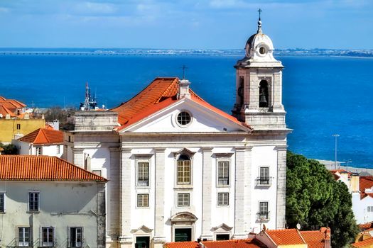 Beautiful Saint Stephen view from the viewpoint of Santa Luzia in Lisbon. The Tagus river in the background on a sunny day