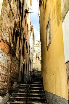 Old colorful and beautiful facades with vintage streetlight in Lisbon streets in Spring.