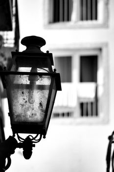 Old colorful and beautiful facades with vintage streetlight in Lisbon streets in Spring.