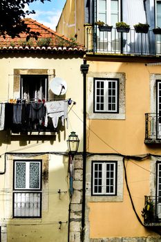 Old colorful and beautiful facades with vintage streetlight in Lisbon streets in Spring.