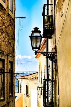 Old colorful and beautiful facades with vintage streetlight in Lisbon streets in Spring.