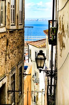 Old colorful and beautiful facades with vintage streetlight in Lisbon streets in Spring.