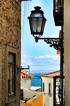 Old colorful and beautiful facades with vintage streetlight in Lisbon streets in Spring.
