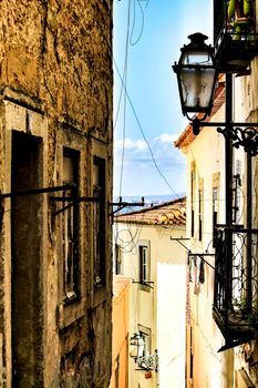Old colorful and beautiful facades with vintage streetlight in Lisbon streets in Spring.