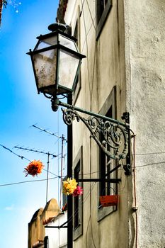 Old colorful and beautiful facades with vintage streetlight in Lisbon streets in Spring.