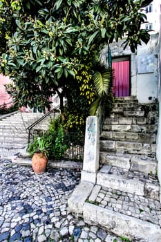 Narrow and colorful streets with majestic facades, windows and balconies of Lisbon city in Portugal in a cloudy day