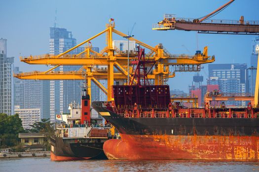 Container ship in export and import business and logistics. Shipping cargo to harbor by crane. Water transport International.