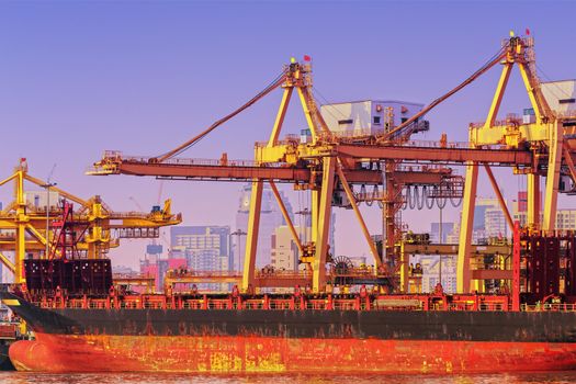Container ship in export and import business and logistics. Shipping cargo to harbor by crane. Water transport International.