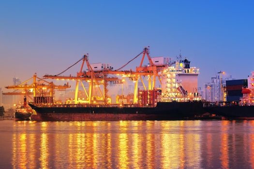 Container ship in export and import business and logistics. Shipping cargo to harbor by crane. Water transport International.