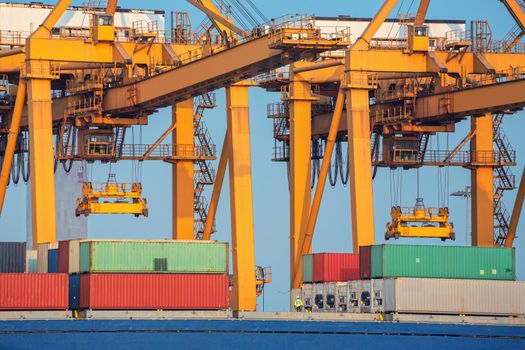 Container ship in export and import business and logistics. Shipping cargo to harbor by crane. Water transport International.