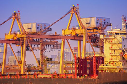 Container ship in export and import business and logistics. Shipping cargo to harbor by crane. Water transport International.