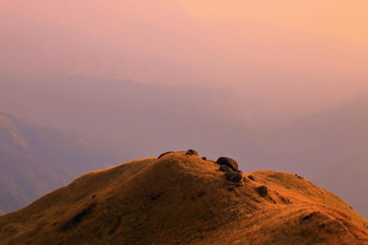 The mountain in the evening there is sunshine on the meadow.