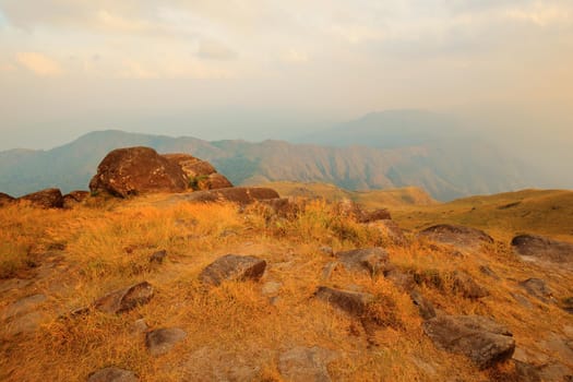 The mountain in the evening there is sunshine on the meadow.