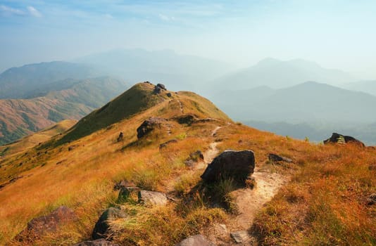 A mountain view full of grass In the evening