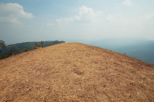 The highest point has mountains and the sky as the background.