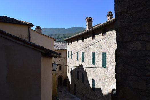 View of an ancient medieval village in the Tuscan countryside, Italy.