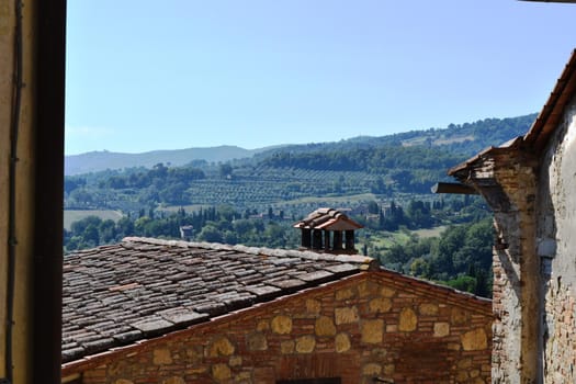 View of an ancient medieval village in the Tuscan countryside, Italy.