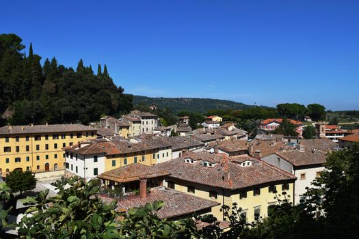 View of an ancient medieval village in the Tuscan countryside, Italy.