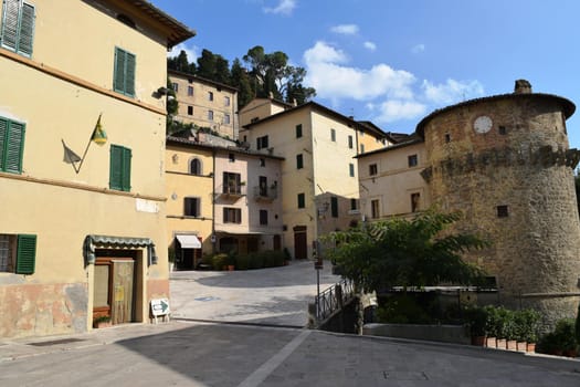 View of an ancient medieval village in the Tuscan countryside, Italy.