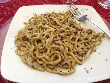 Delicious Italian dish: spaghetti alla chitarra with summer truffle, Tuscany.