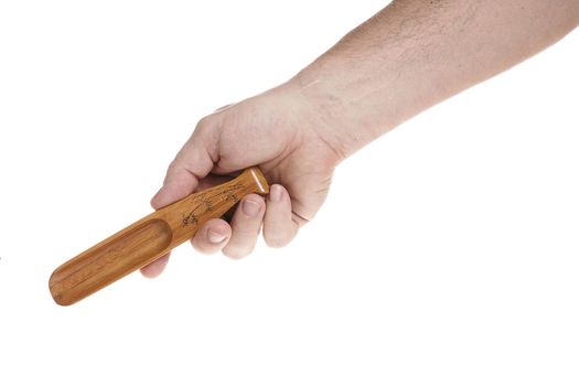 Hand holds a small wooden scoop for cereals on a white background, a template for designers.