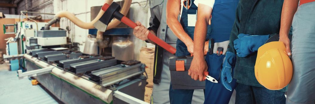 Workers with tools on wooden furniture production background. Industrial cutting machine for automatic wood cutting on background