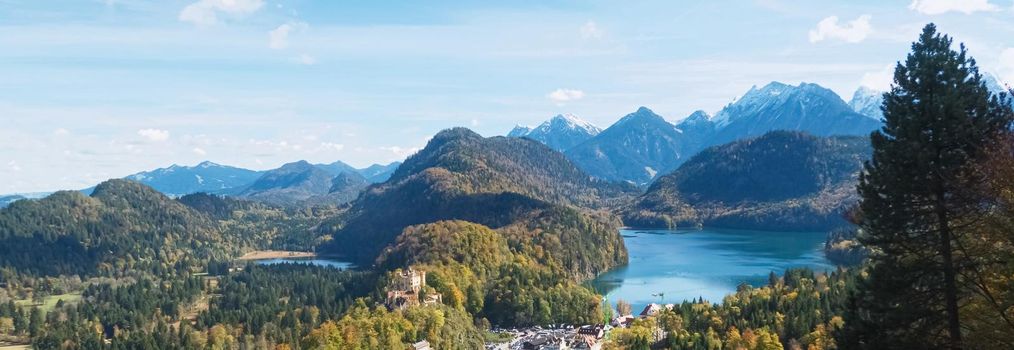 Beautiful nature of European Alps, landscape view of alpine mountains, lake and village on a sunny day, travel and destination scenery