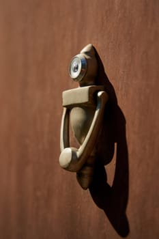 Unusual stylish door knocker in the shape of a robot.