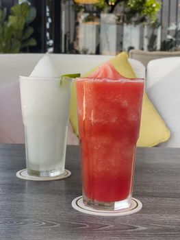 Watermelon smoothie in glass on grey table, stock photo