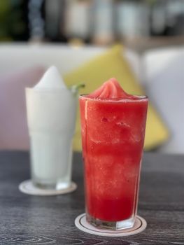 Watermelon smoothie in glass on grey table, stock photo