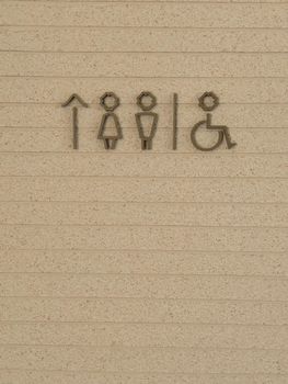 Restroom symbol on brown background, stock photo