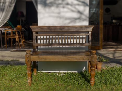 Brown wooden bench in garden, stock photo