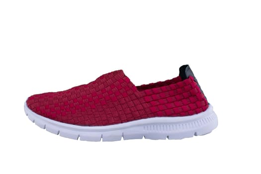 Red sneaker on a white sole. Sport shoes on a white background.