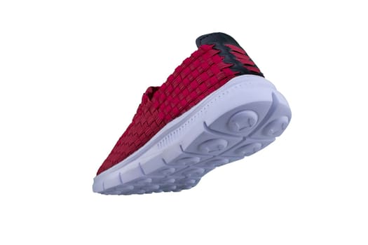 Red sneaker on a white sole. Sport shoes on a white background.