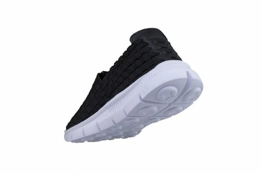 Black sneakers on white soles. Sport shoes on a white background.
