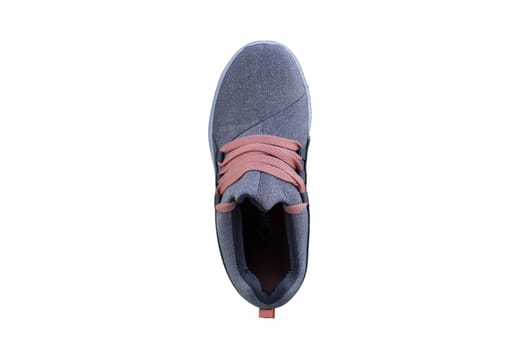 Gray sneaker with orange laces. Sport shoes on a white background top view