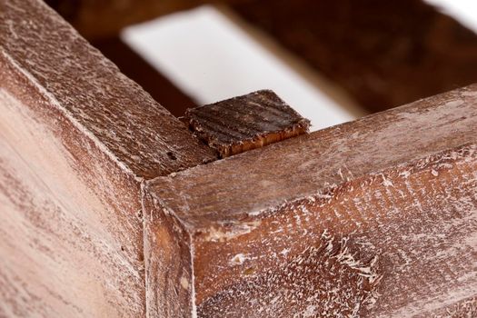 Fragment of a wooden box close-up on a white background