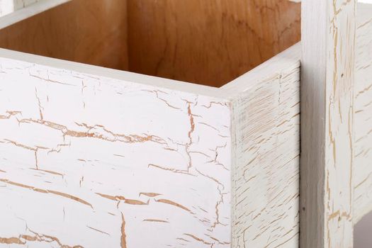 Fragment of a wooden box on a white background close-up