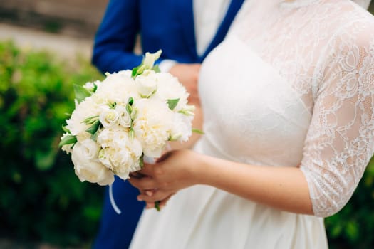 Wedding roses and peonies in the hands of the bride. Wedding in Montenegro.