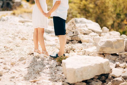 Couple holding hands in the mountains. Newlyweds in the mountains holding hands. Wedding in Montenegro.
