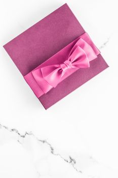 Birthday, wedding and girly branding concept - Pink gift box with silk bow on marble background, girl baby shower present and glamour fashion gift for luxury beauty brand, holiday flatlay art design