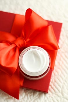 Beauty, cosmetics and skincare styled concept - Luxury face cream jar and red gift box