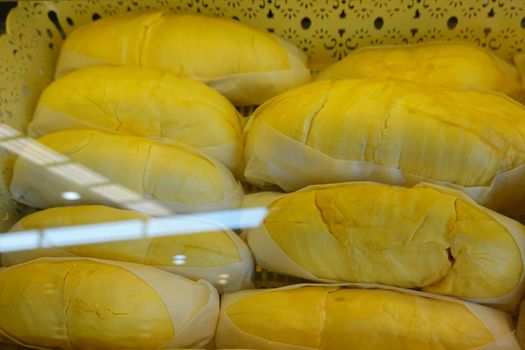 durian fruit in packages on sale in market, yellow durian in packaging as seasonal fruit of Thailand. 