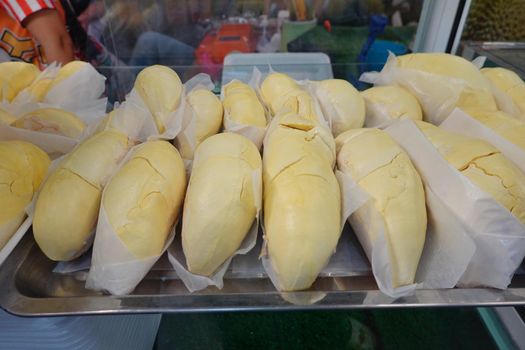 durian fruit in packages on sale in market, yellow durian in packaging as seasonal fruit of Thailand. 