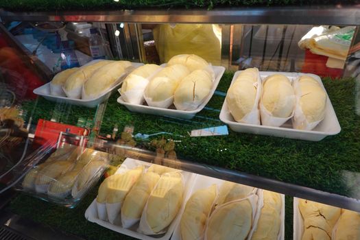 durian fruit in packages on sale in market, yellow durian in packaging as seasonal fruit of Thailand. 