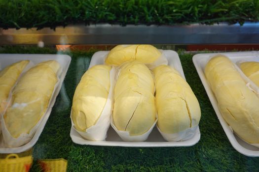 durian fruit in packages on sale in market, yellow durian in packaging as seasonal fruit of Thailand. 