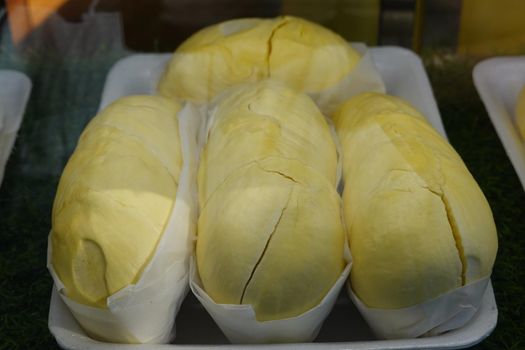 durian fruit in packages on sale in market, yellow durian in packaging as seasonal fruit of Thailand. 