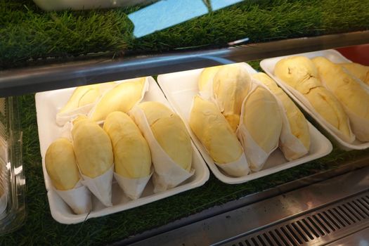 durian fruit in packages on sale in market, yellow durian in packaging as seasonal fruit of Thailand. 