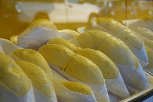 durian fruit in packages on sale in market, yellow durian in packaging as seasonal fruit of Thailand. 